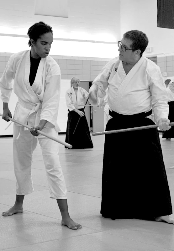 2 aikidokas practicing with a staff (Jo)